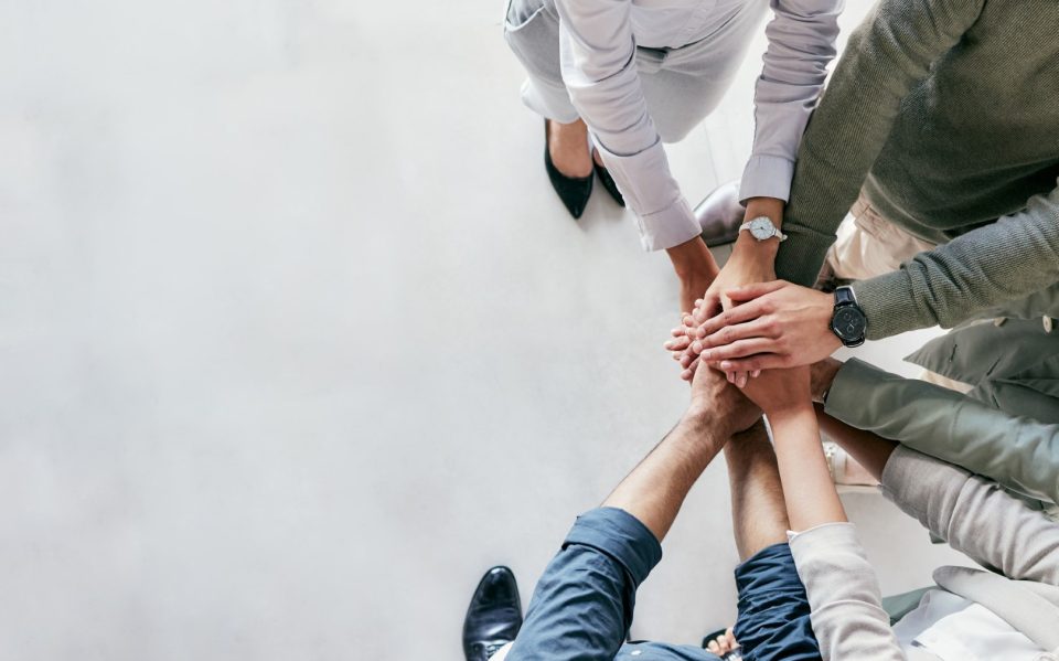 Shot of a group of unrecognizable businesspeople stacking their hands at work.